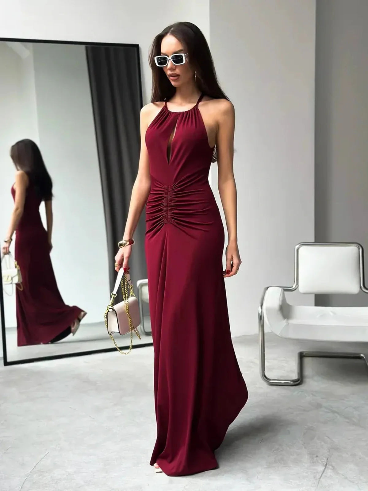Elegant burgundy Maxi Dress Élan with draped halter design and ruched waist, perfect for evening wear.