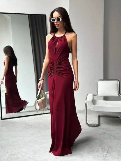 Elegant burgundy Maxi Dress Élan with draped halter design and ruched waist, perfect for evening wear.
