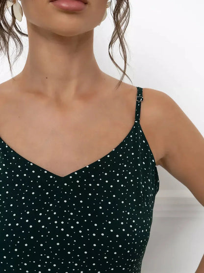 Close-up of the Emerald Whisper Maxi Dress featuring a dotted print and elegant spaghetti straps.