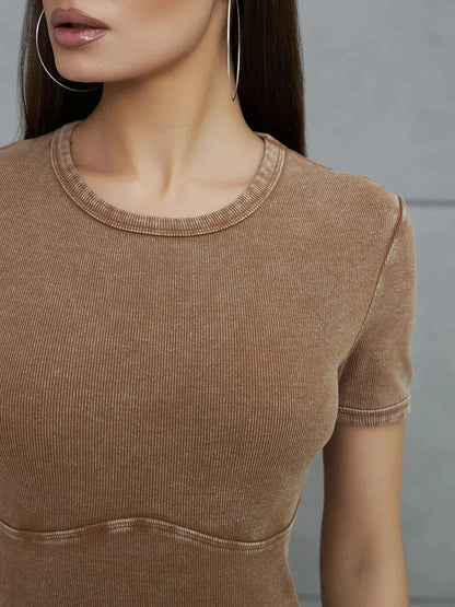 Close-up of a woman wearing a Sculpted Ease Maxi Dress in washed tobacco, highlighting its stretch fabric and minimalist design.