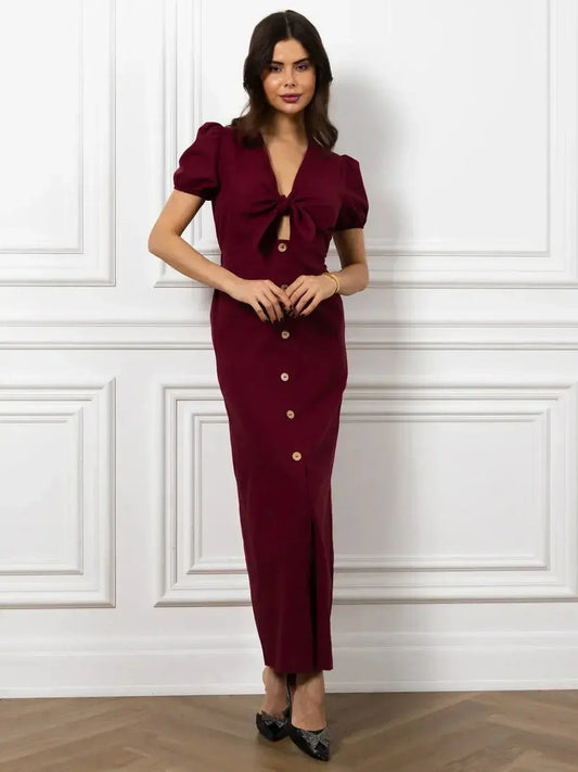 Elegant maxi dress in merlot with front bow, button detail, and puff sleeves for a sophisticated look.