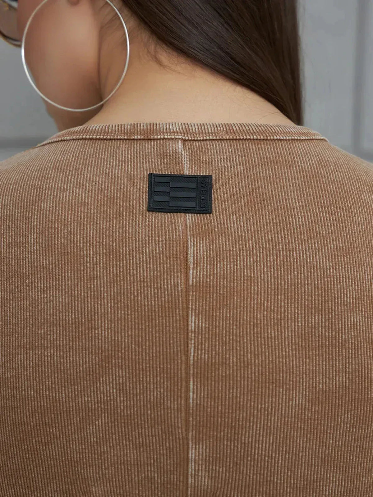 Close-up of the back of a Sculpted Ease Maxi Dress in washed tobacco with minimalist branding tag.