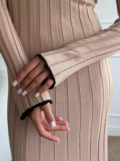 Close-up of hands in Sahara Curve Maxi Dress, showcasing soft ribbed texture and elegant design details in sandstone beige.