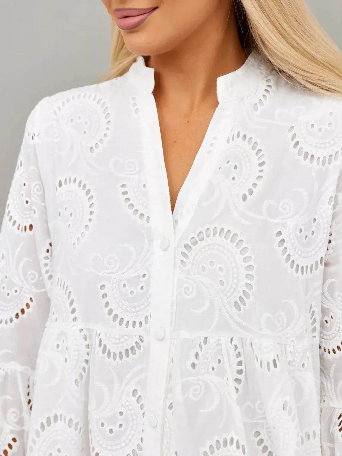Close-up of a woman wearing a Broderie Cotton Maxi Dress featuring intricate embroidery and a button-down front.