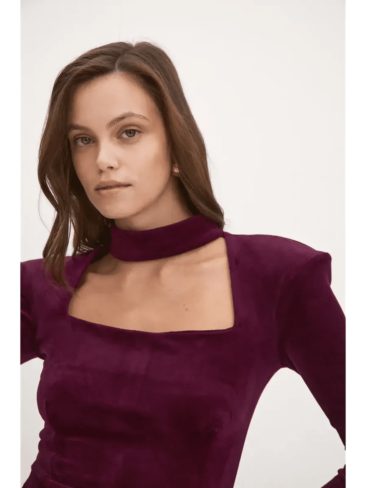 Model wearing the Velvet Aura long sleeve bodycon dress in deep burgundy with choker neckline, perfect for parties.