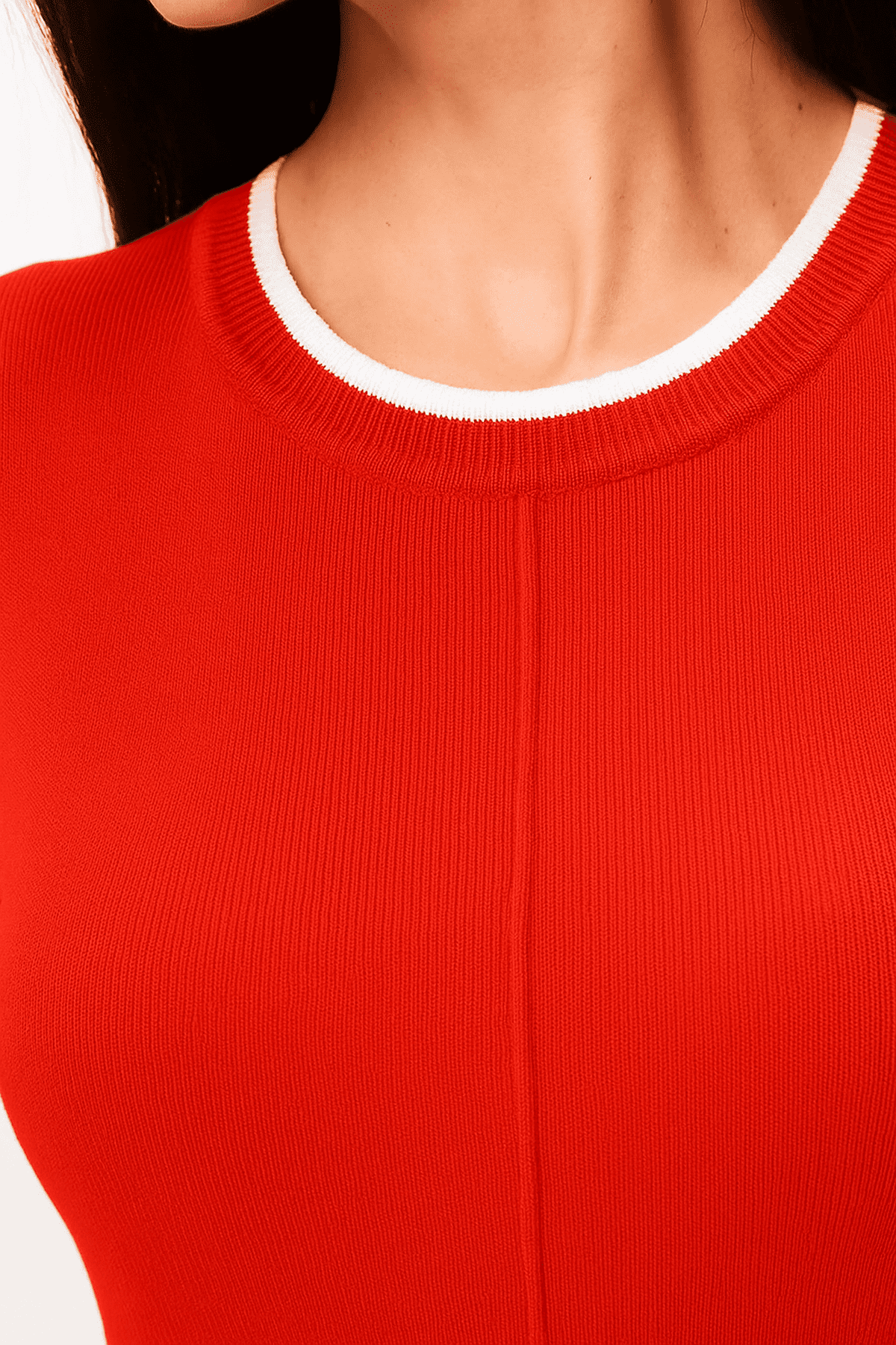 Close-up of the neckline detail of the Capella Mini Dress by Lauven featuring contrast trim and soft knit.