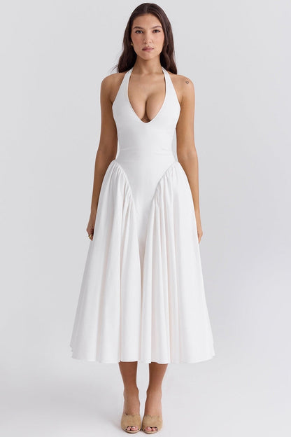 Elegant white maxi dress with a halter neckline and flowy skirt, perfect for summer weddings or formal occasions.