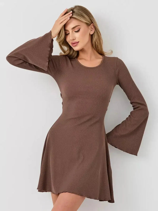 Model wearing a Flare Hour Mini dress by Lauven, featuring bell sleeves and a flared hem, showcasing elegance and comfort.