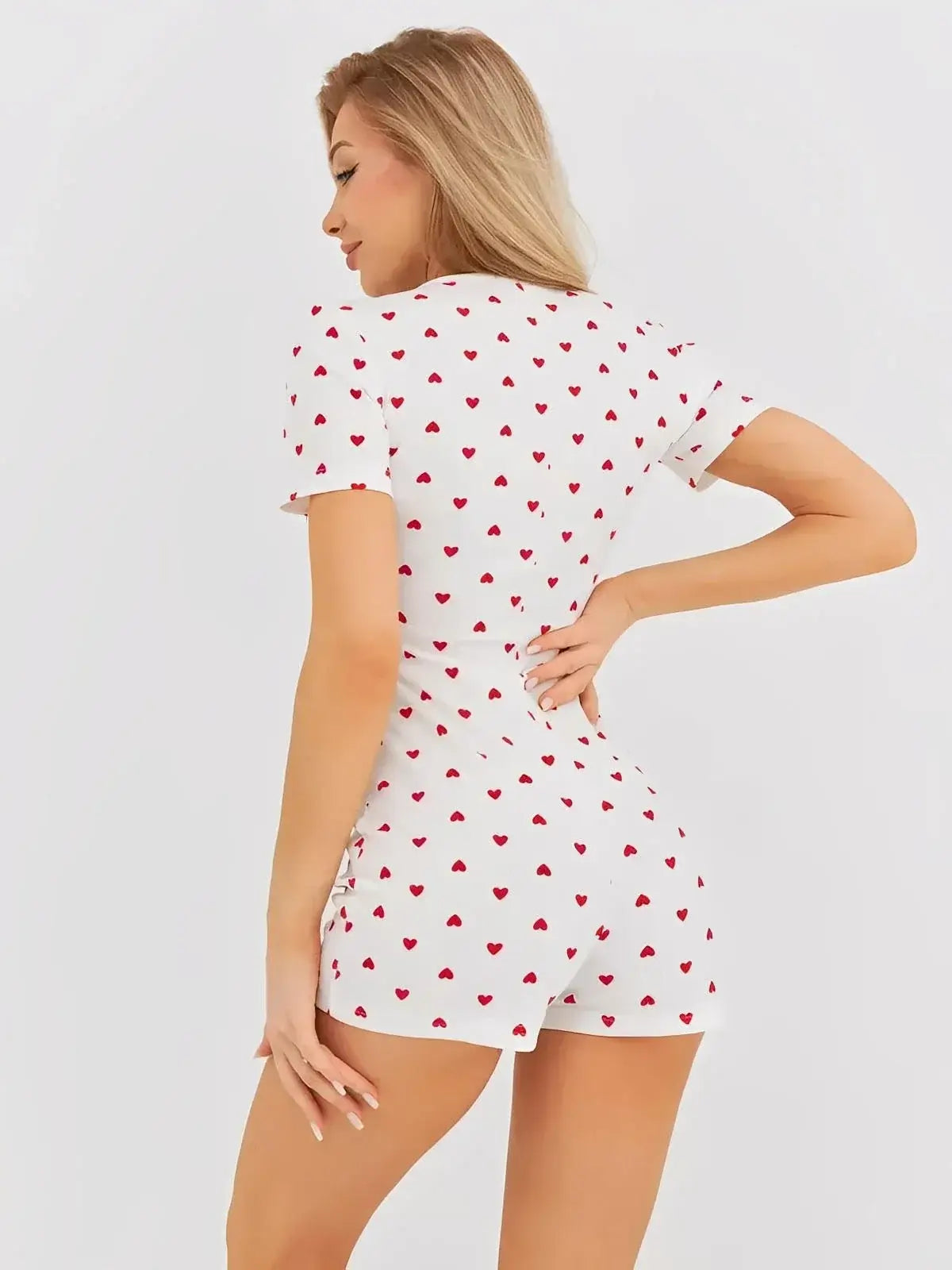 Heartprint Playsuit by Lauven - women's V-neck romper in white with playful red heart print, showcasing a relaxed fit.