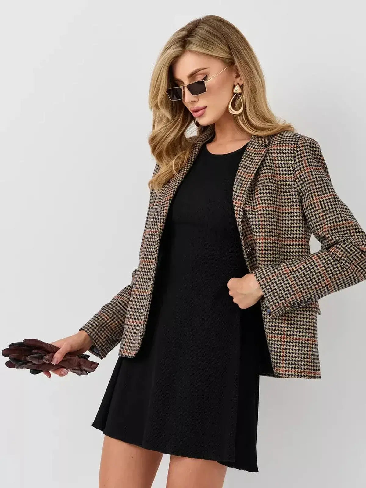 Model showcasing a stylish look with the Velvet Hour mini dress and a chic blazer from Lauven, emphasizing modern fashion.