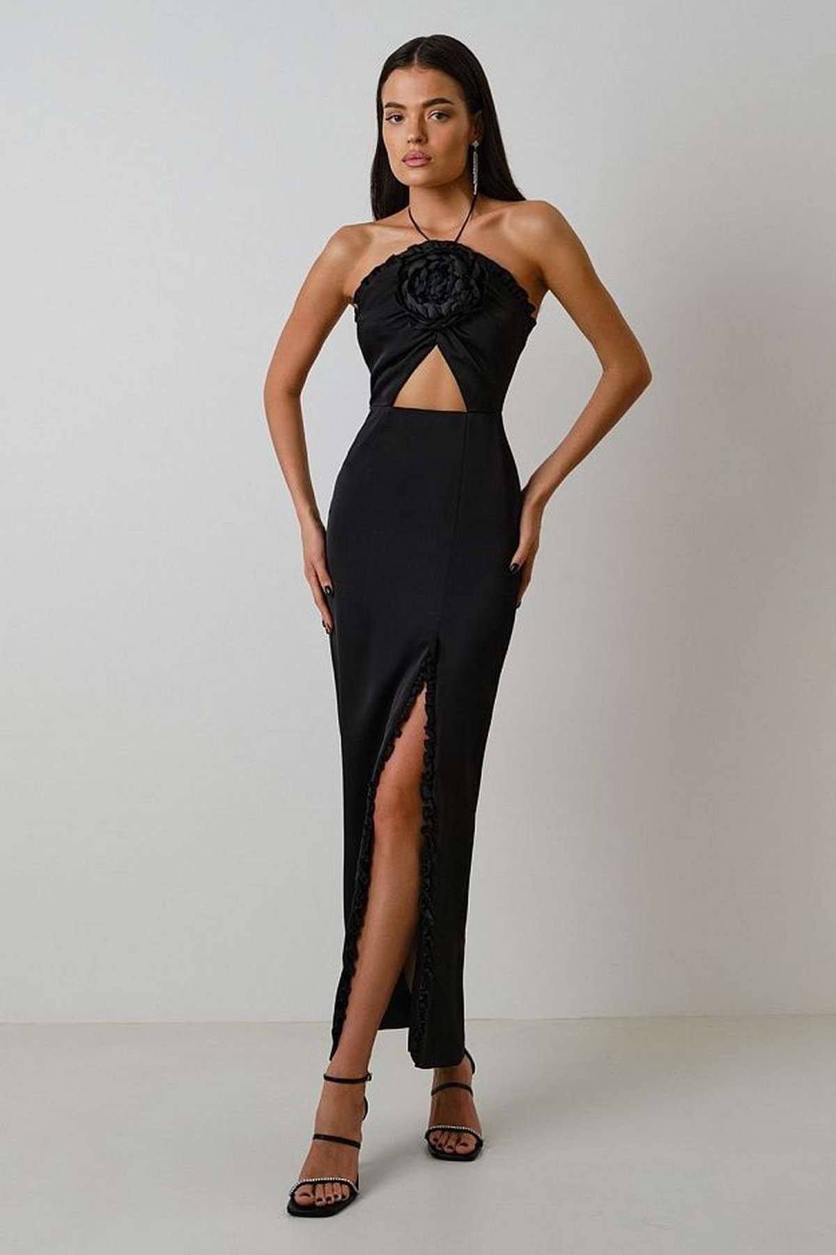 Elegant black maxi dress with a 3D rose detail and thigh-high slit, perfect for evening events or special occasions.