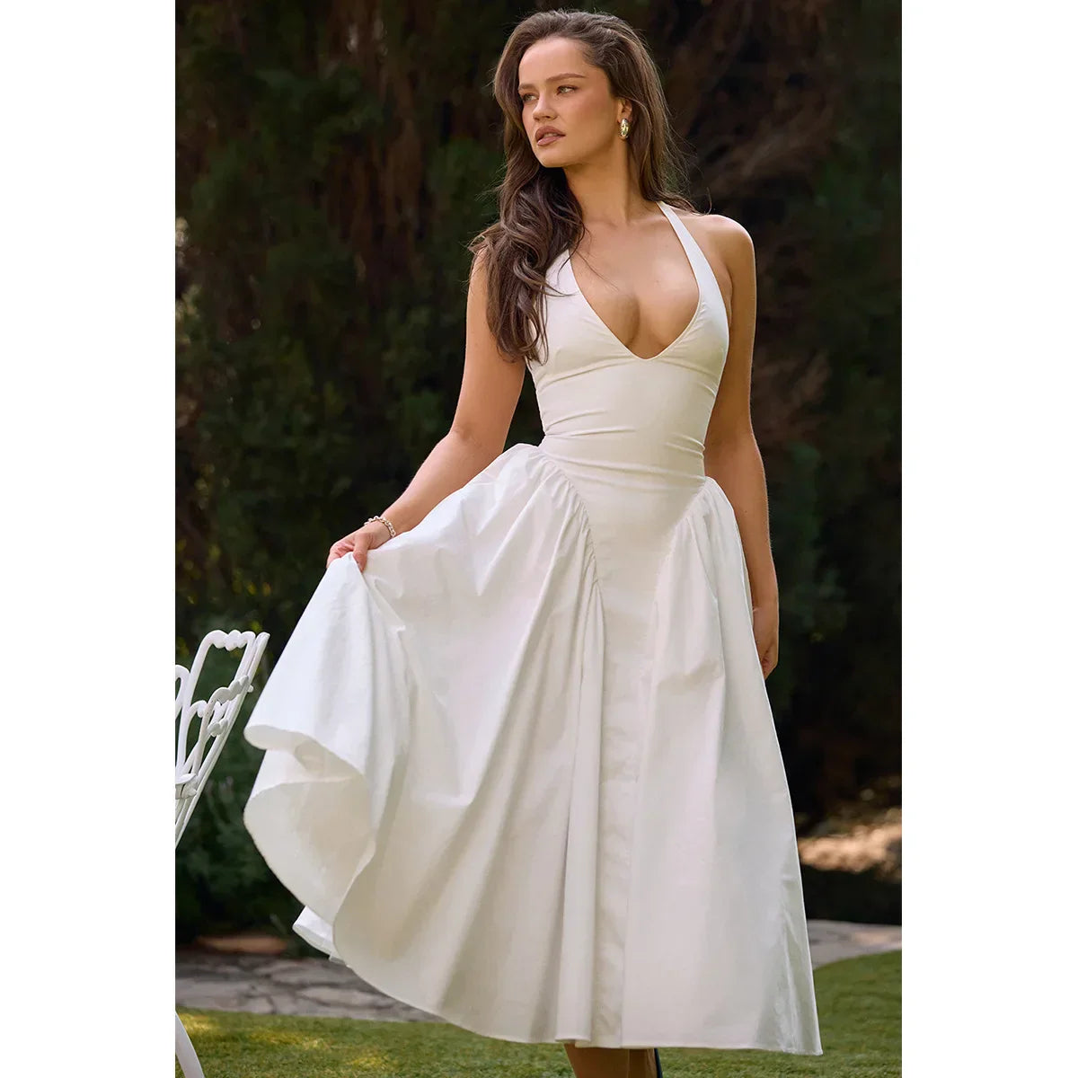 Elegant white Celeste maxi dress with a flattering silhouette, perfect for weddings or summer events.