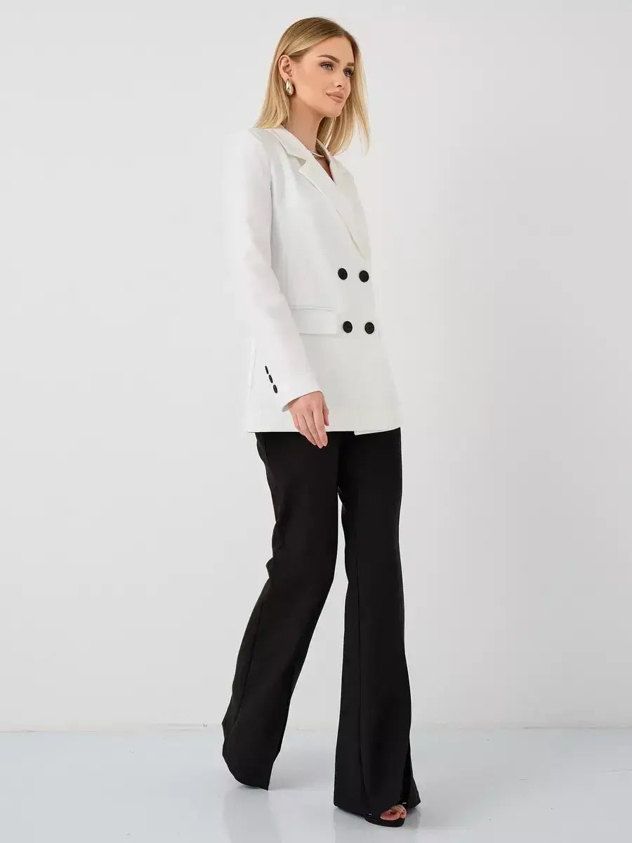 Woman wearing Alabaster Blazer by Lauven, an oversized double-breasted white tailored jacket paired with black pants.