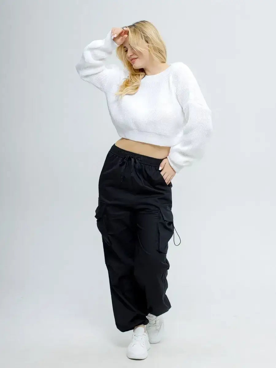 Model wearing Alba Pullover by Lauven, a lightweight knit in soft white with oversized cropped design.