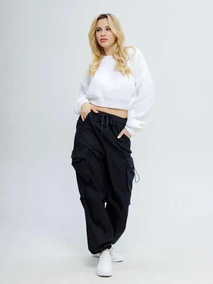Alba Pullover by Lauven in soft white worn with black cargo pants for a stylish spring look.