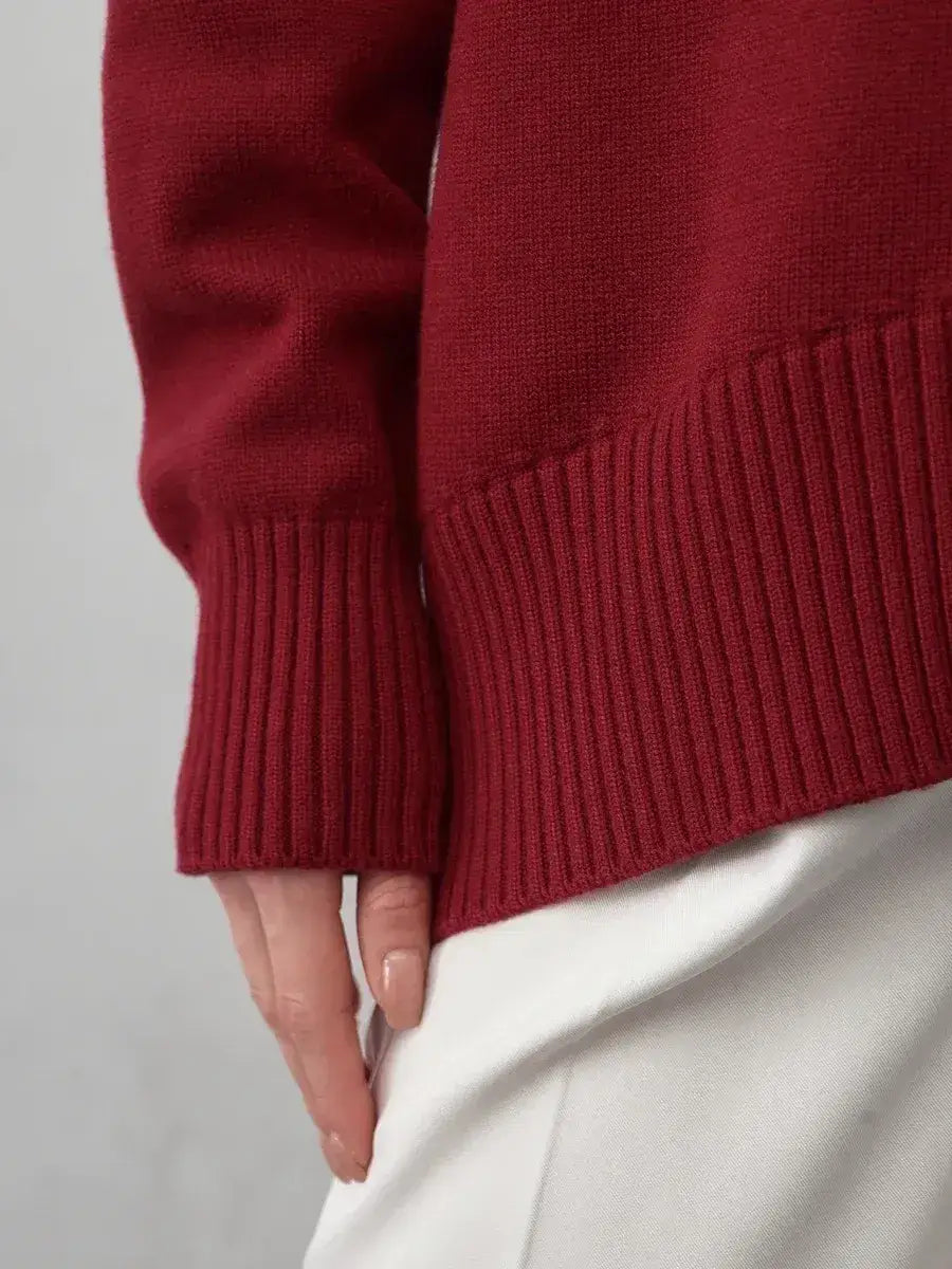 Close-up of the Arden Sweater by Lauven, showcasing the burgundy knit and ribbed cuffs for modern elegance.