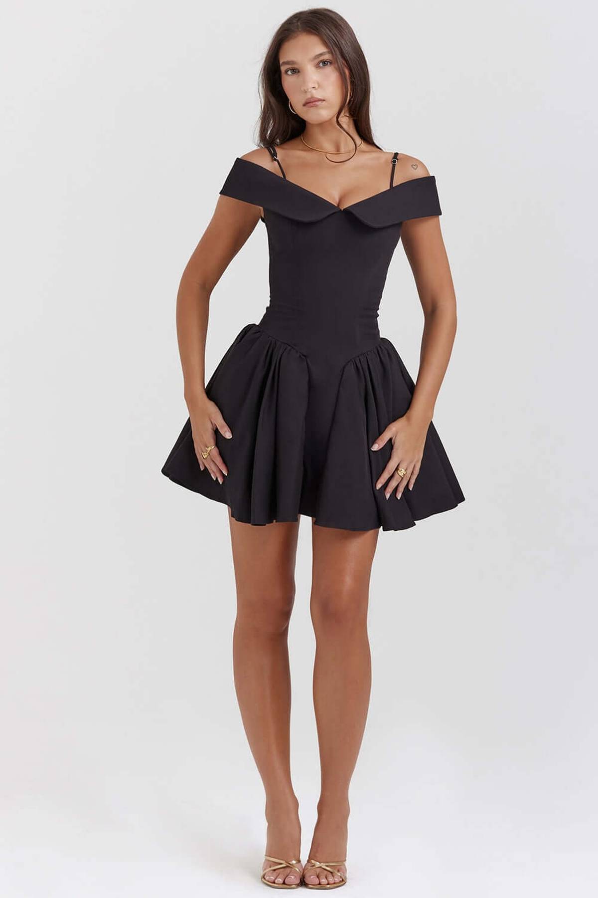 Black off-shoulder mini dress with flared skirt, perfect for cocktail parties and formal occasions.