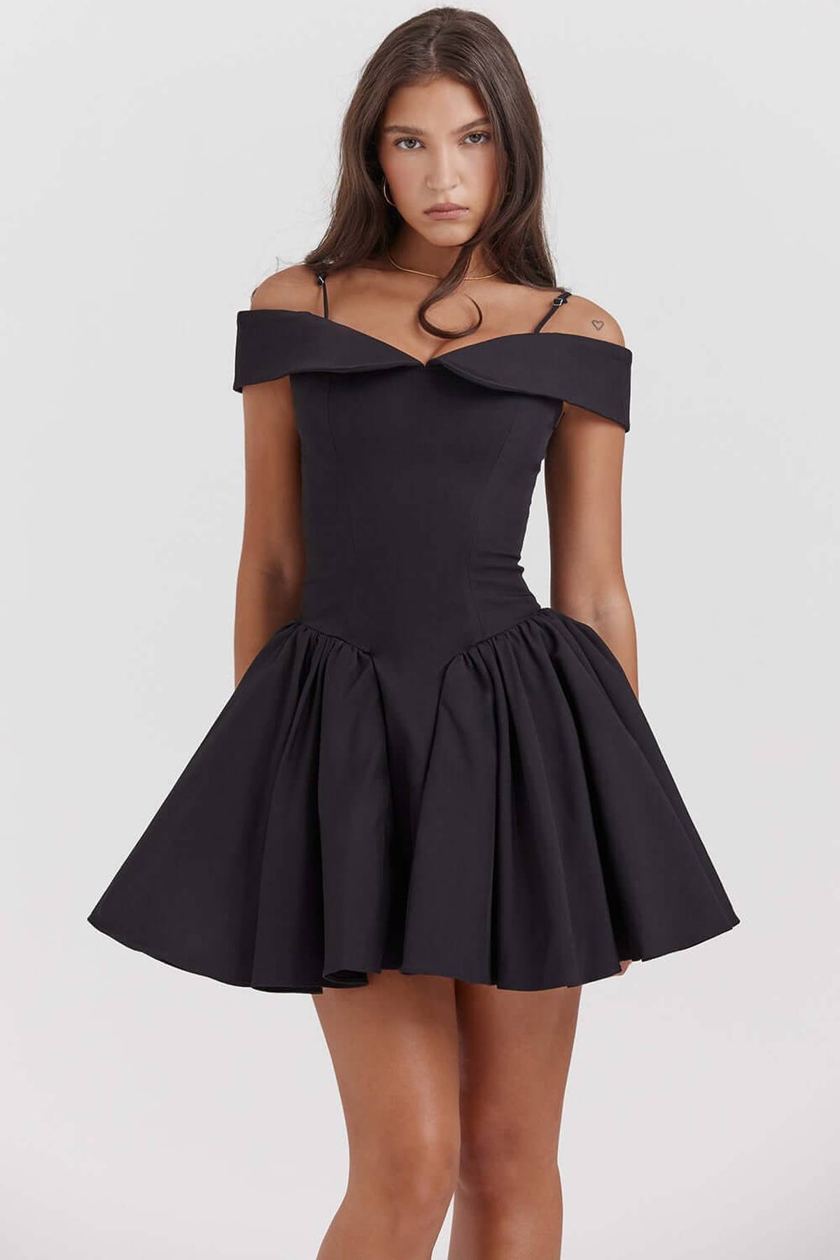 Elegant off-shoulder black mini dress featuring a flared skirt, perfect for cocktail parties and evening events.