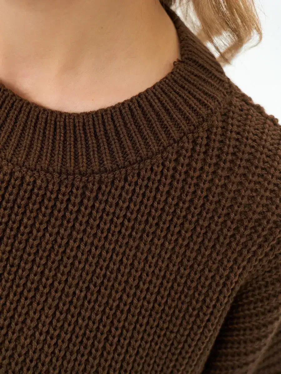 Close-up of the textured knit round neckline of the Atlas Sweater by Lauven in rich brown.