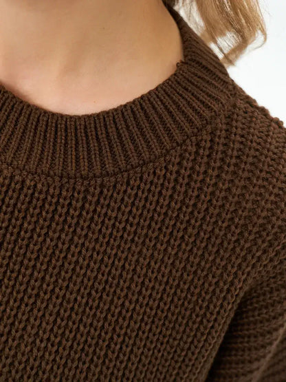 Close-up of the textured knit round neckline of the Atlas Sweater by Lauven in rich brown.
