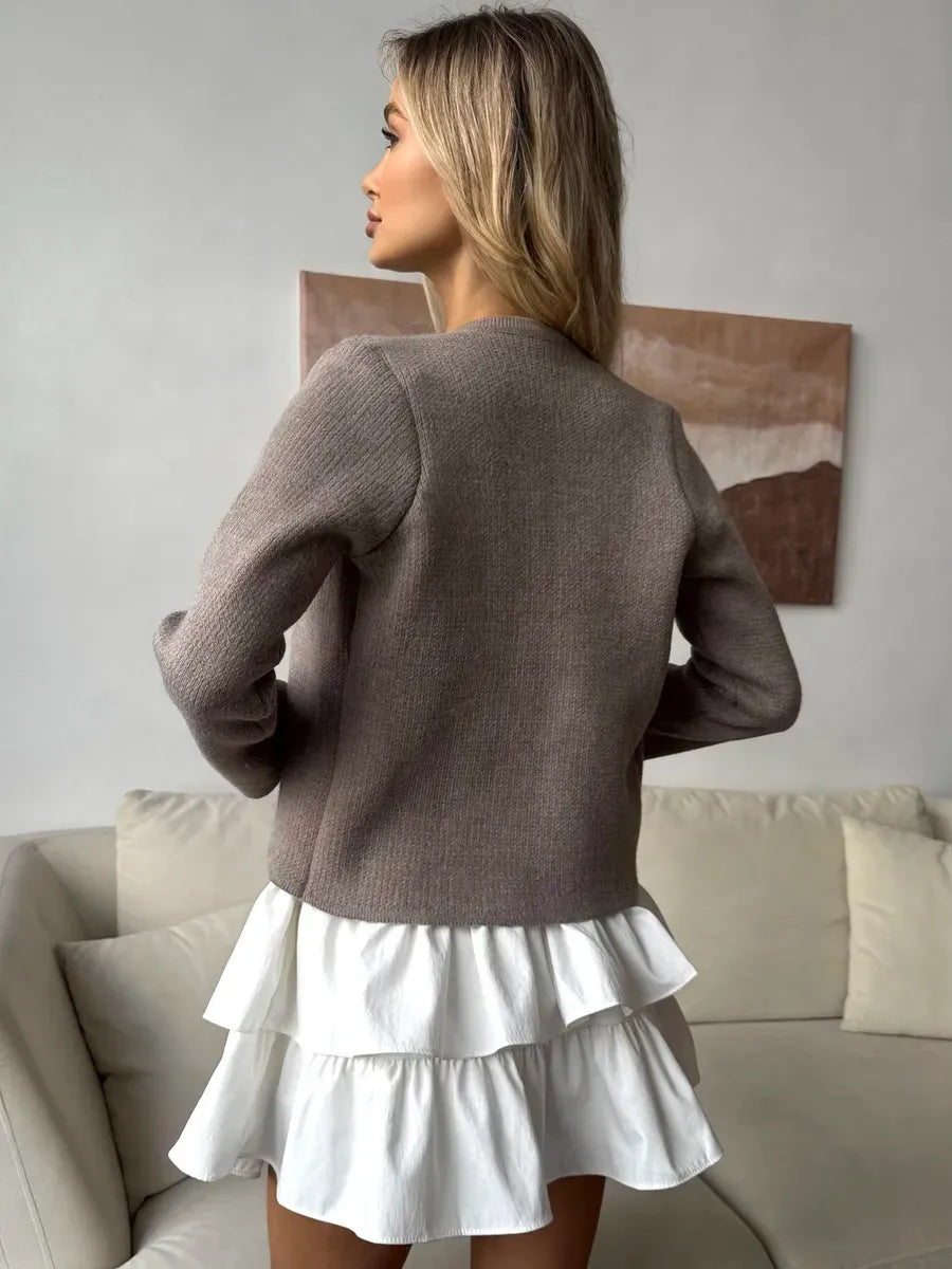 Aveline Cardigan by Lauven, soft cappuccino cropped knitwear styled with a white ruffled dress, perfect for modern elegance.