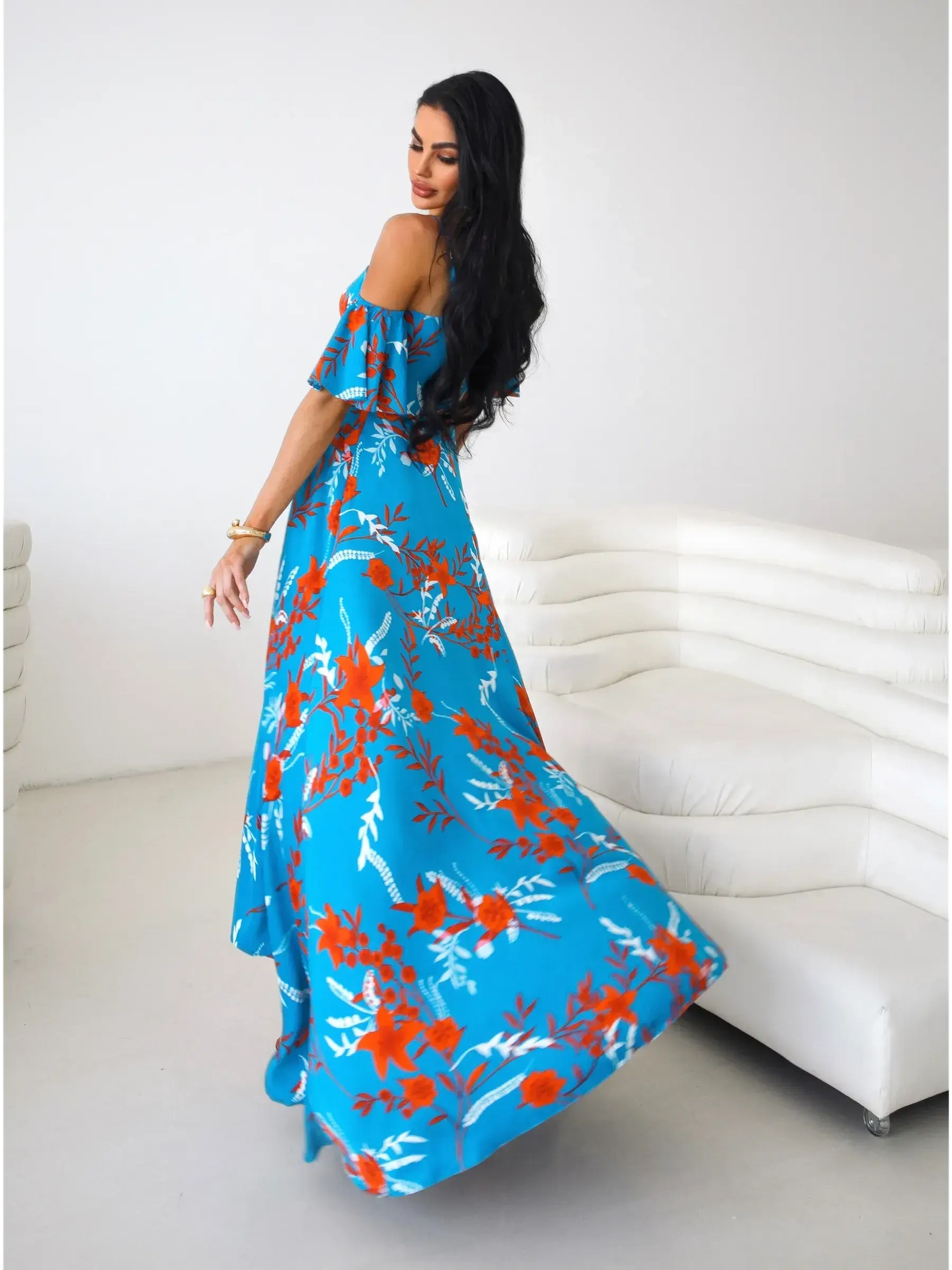 Azure Bloom Maxi Dress featuring vibrant red and white floral designs, off-shoulder ruffle sleeves, and a flowing silhouette.