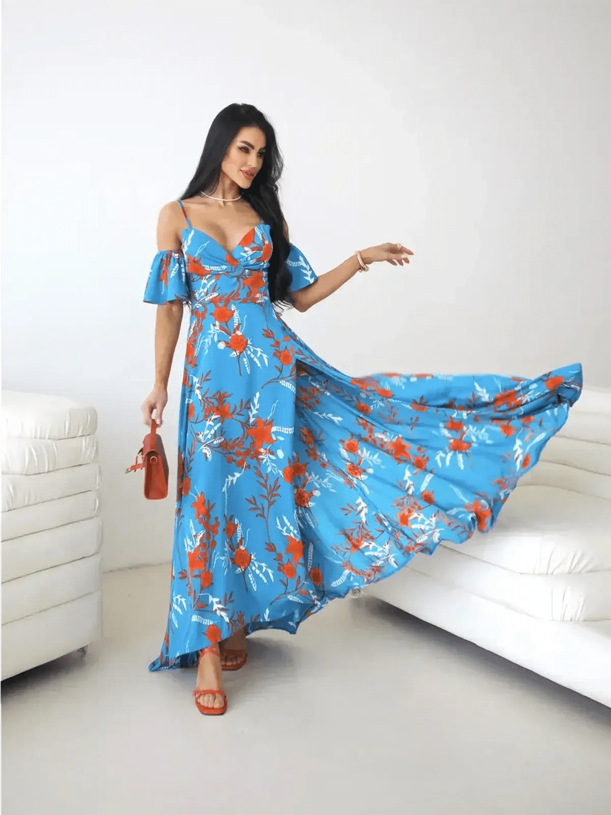 Azure Bloom Maxi Dress featuring off-shoulder ruffle sleeves and a thigh-high slit against a blue floral backdrop.