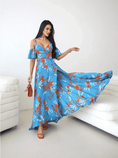 Azure Bloom Maxi Dress featuring off-shoulder ruffle sleeves and a thigh-high slit against a blue floral backdrop.