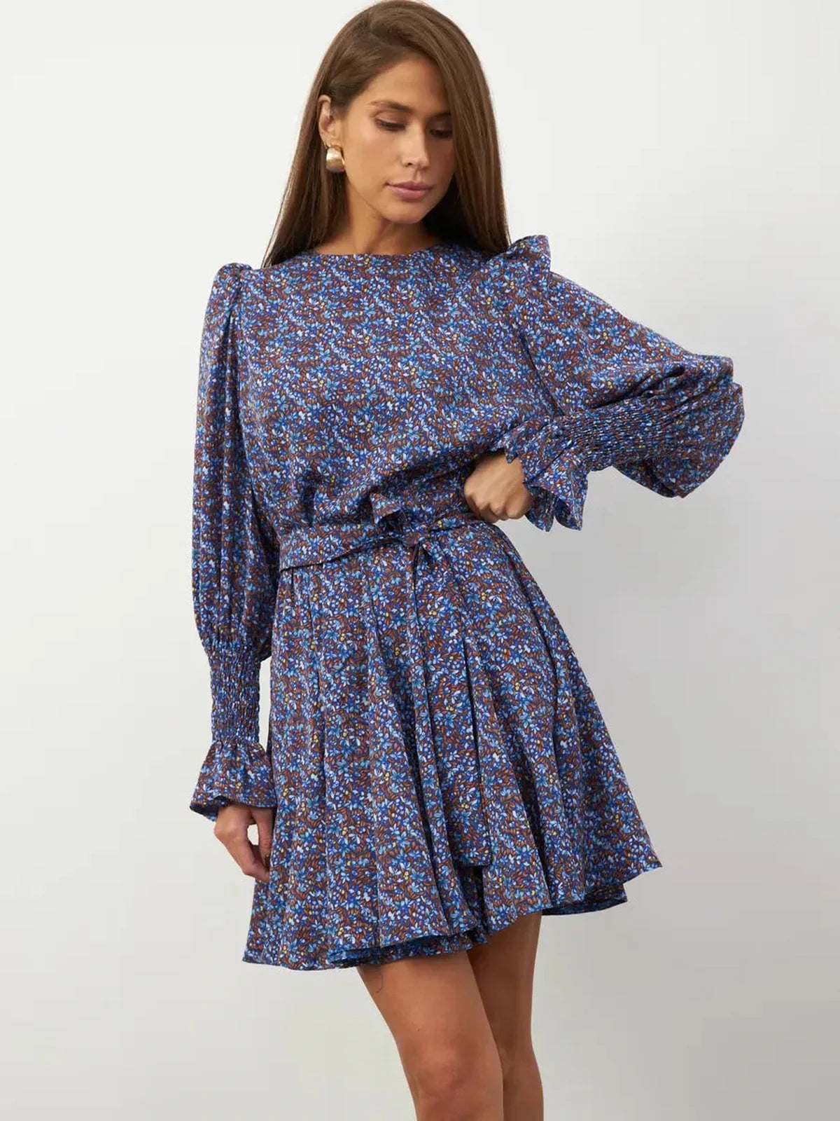 Azure Bloom Mini Dress featuring vibrant blue floral patterns, long sleeves, and a flattering elasticated waist.