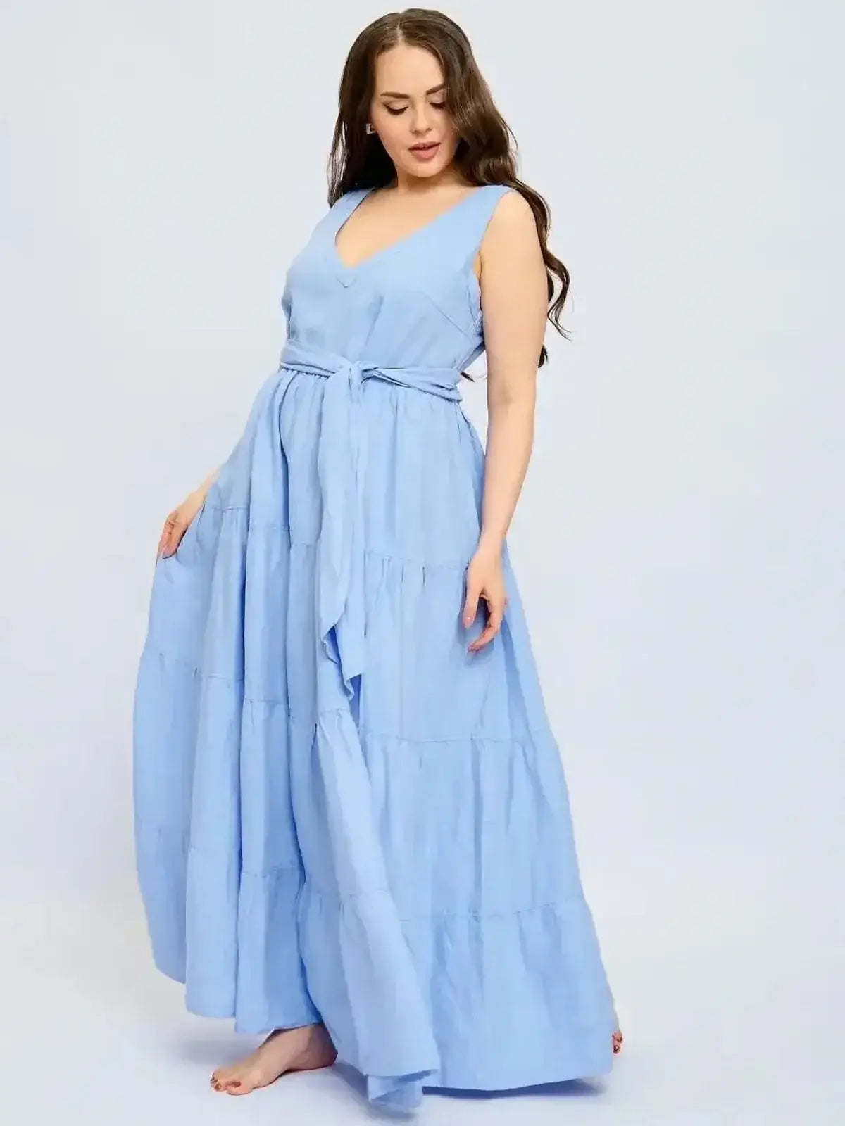 Azure Breeze Maxi Dress in light blue linen with V-neck and tiered skirt, featuring a cinched waist and self-tie belt.