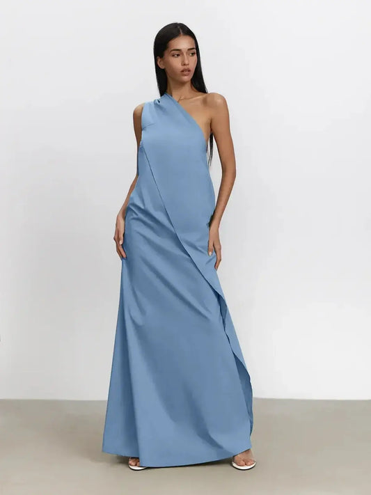 Model wearing an elegant Azure Drape Maxi Dress with a one-shoulder silhouette and fluid A-line cut in soft blue.