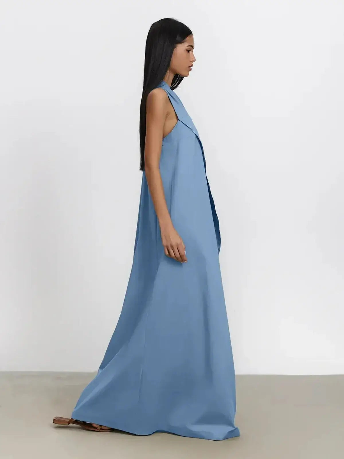Azure drape maxi dress on model highlighting elegant one-shoulder silhouette and fluid A-line flow in soft blue.