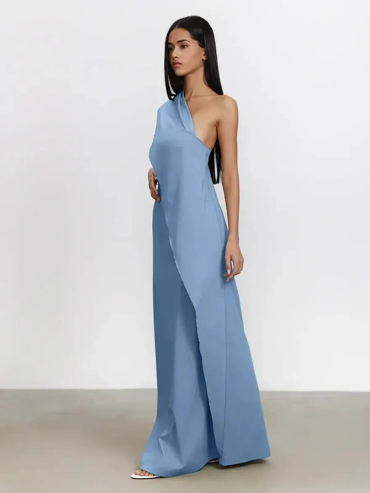 Azure Drape Maxi Dress featuring an elegant one-shoulder design and fluid A-line silhouette in soft blue.