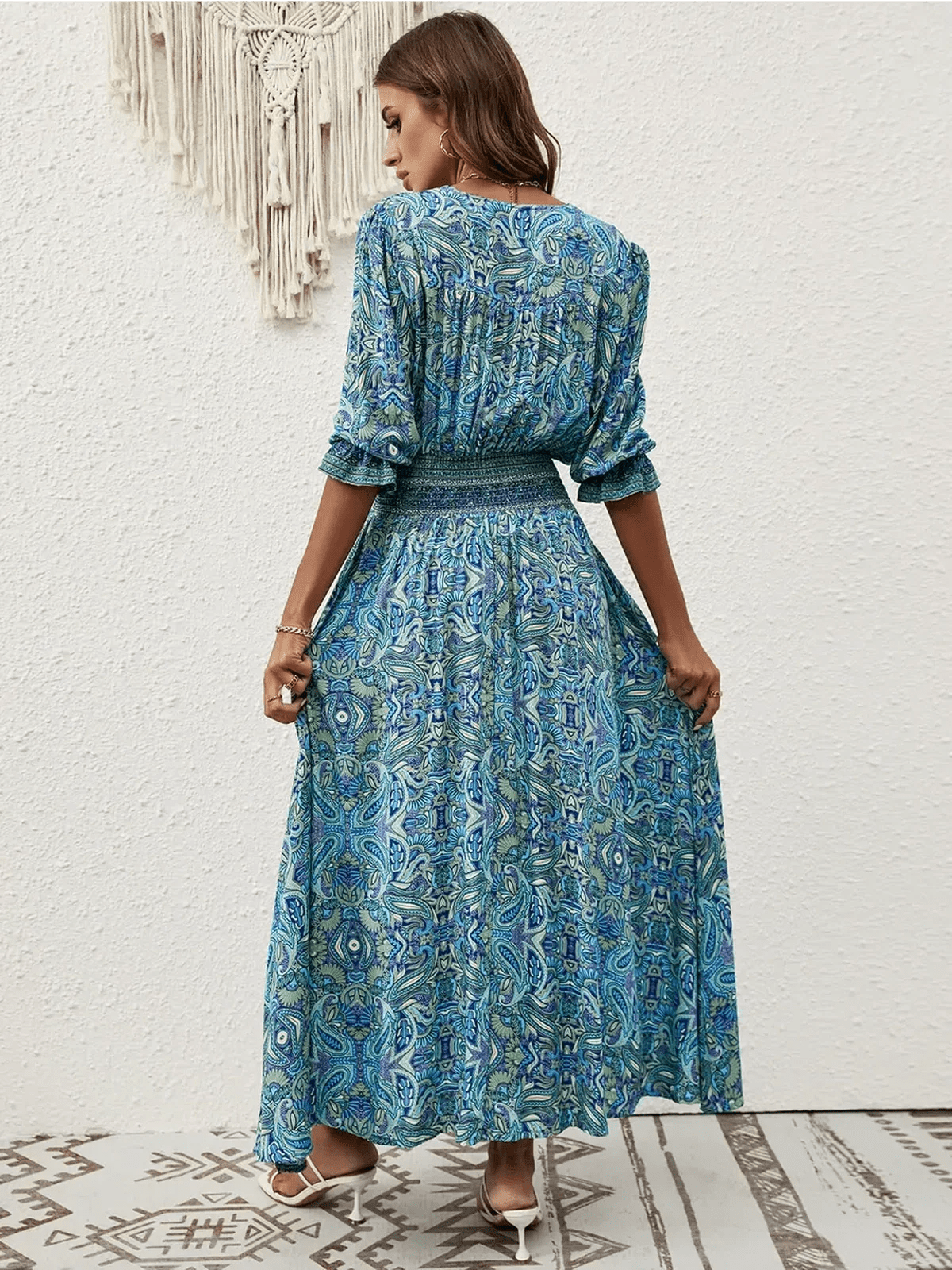 Back view of Azure Drift Maxi Dress featuring a paisley print and smocked waistline, perfect for summer outings.