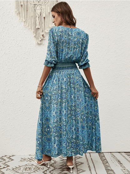 Back view of Azure Drift Maxi Dress featuring a paisley print and smocked waistline, perfect for summer outings.