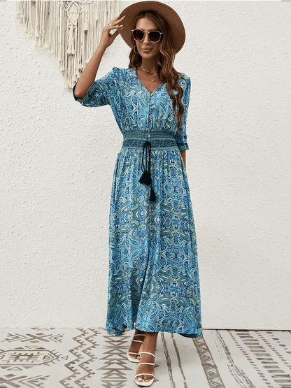Azure Drift Maxi Dress featuring a vibrant paisley print, smocked waist, and boho-chic style for summer outings.