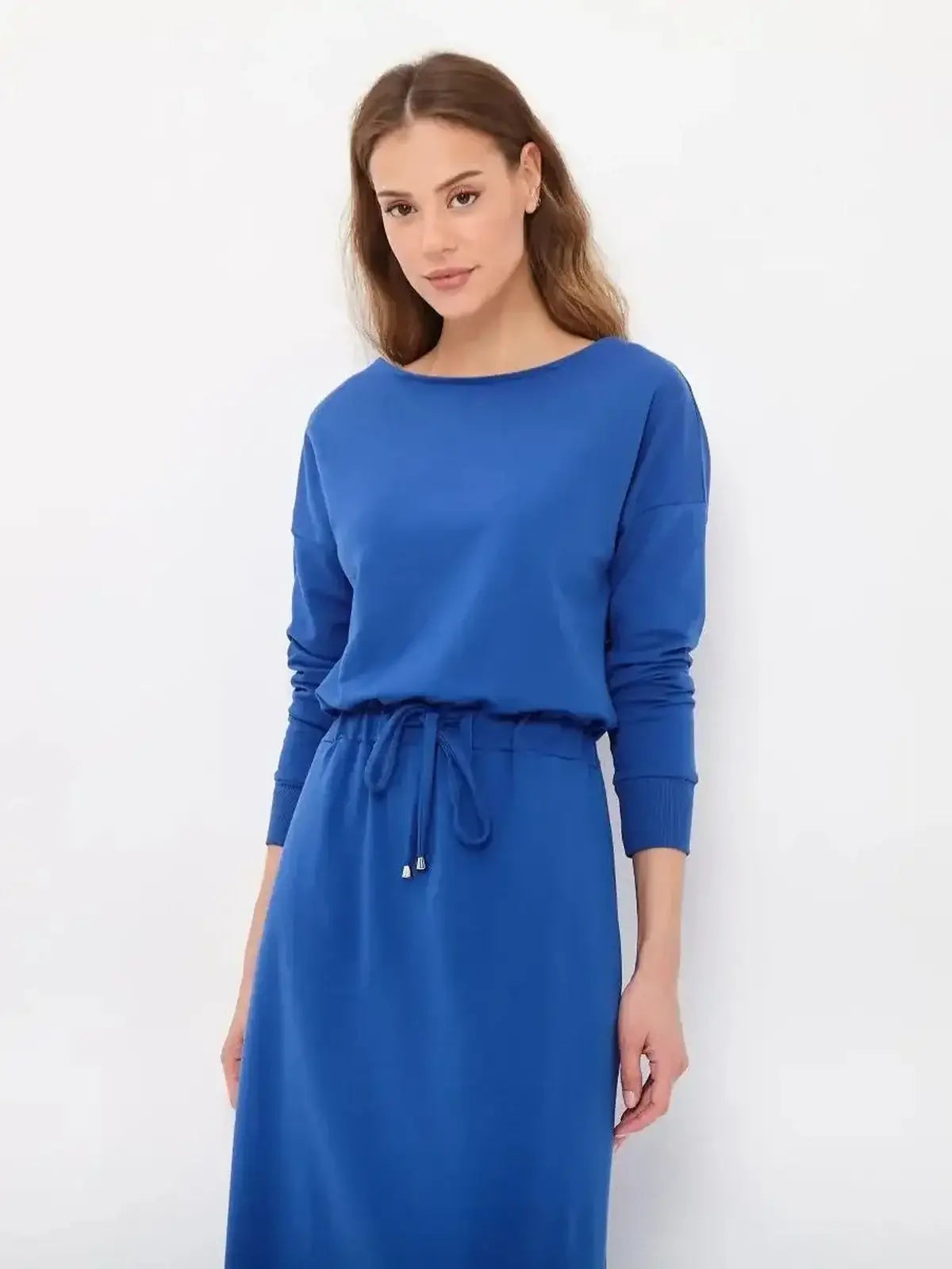 Model showcasing the Azure Ease Maxi Dress in cornflower blue with a relaxed fit and drawstring waist for effortless elegance.