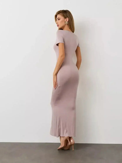 Bare Essence Maxi Dress by Lauven, showcasing a woman in a neutral-toned, fitted silhouette from the back.
