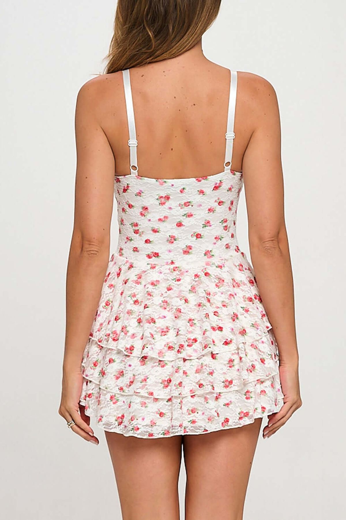 Back view of the Bea Mini Dress featuring a floral lace design and tiered ruffles, perfect for summer outings.