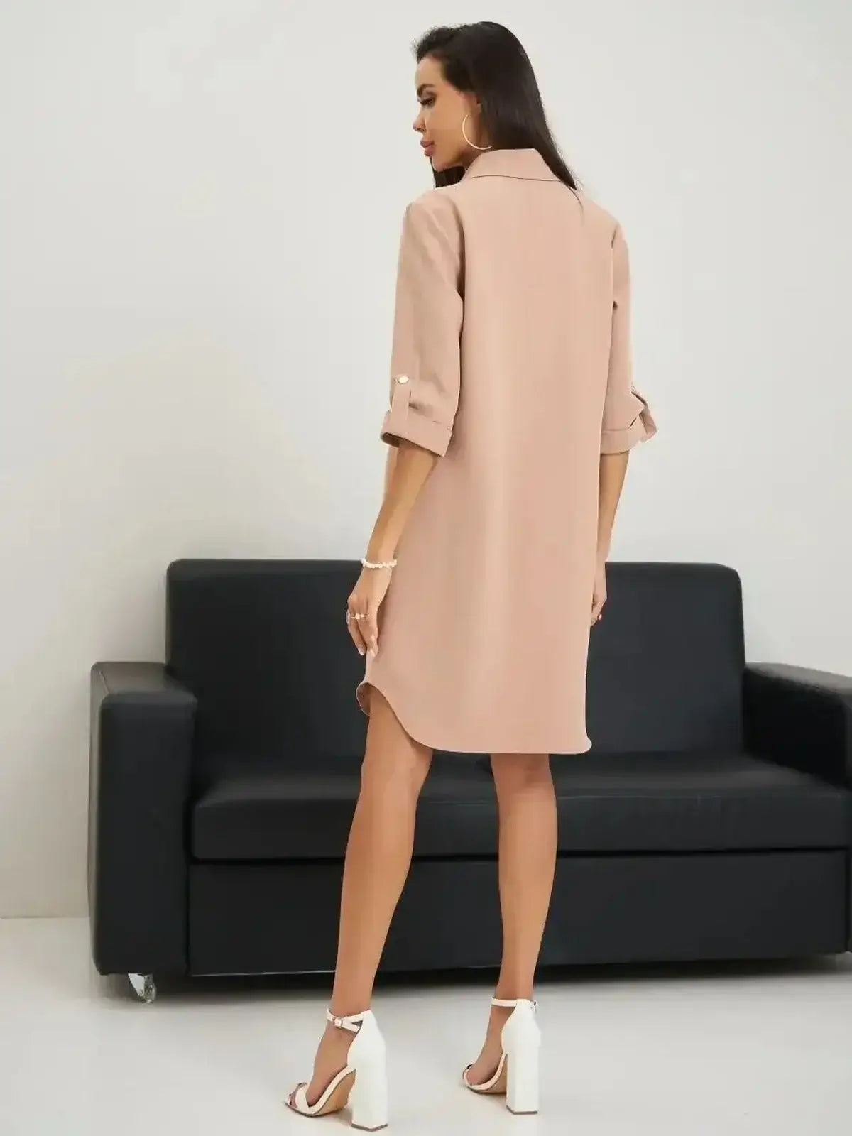 Elegant belted mini dress in blush, showcasing a structured silhouette and crisp collar, perfect for summer outings.