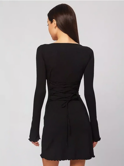 Back view of a sculpting black mini dress with lace-up detail and long sleeves, perfect for summer or formal occasions.