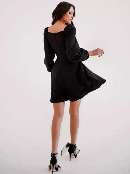 Back view of a chic black mini dress with puff sleeves and a square neckline, perfect for cocktail or summer events.