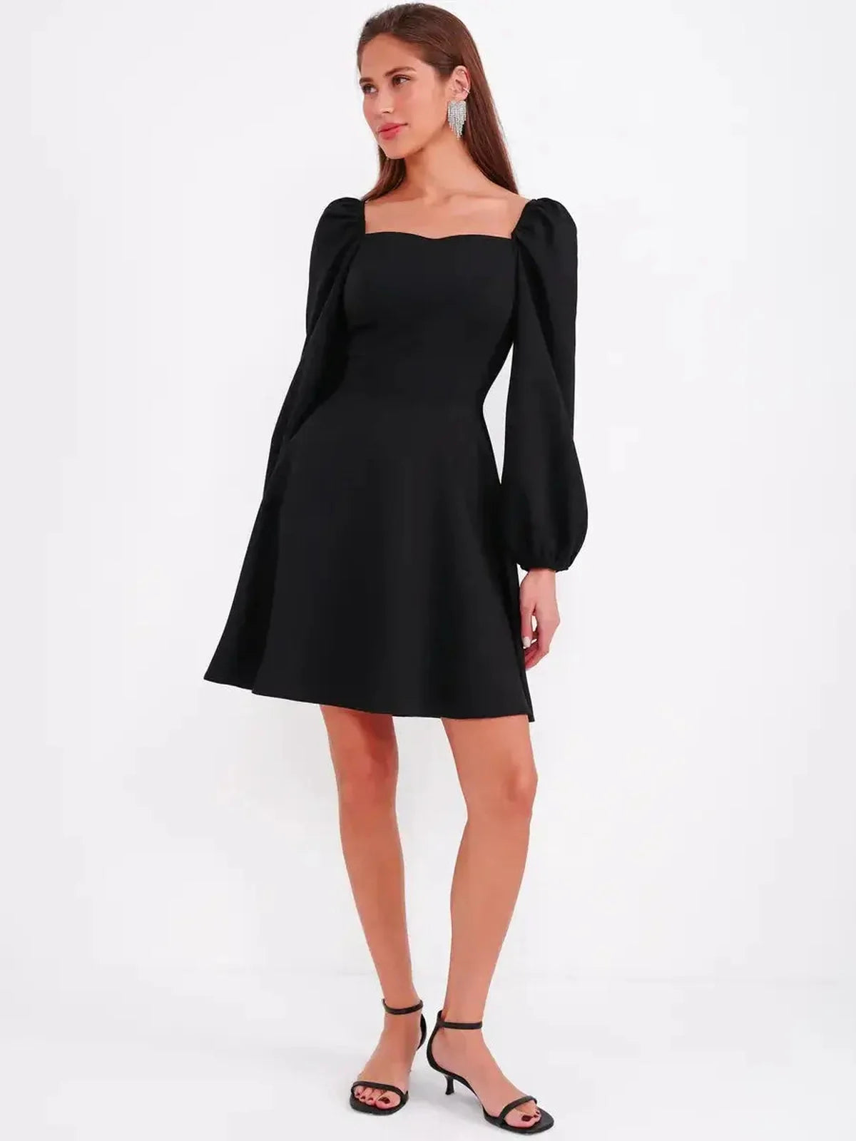 Black mini dress with sculpted bodice and puff sleeves, perfect for cocktail or formal occasions.