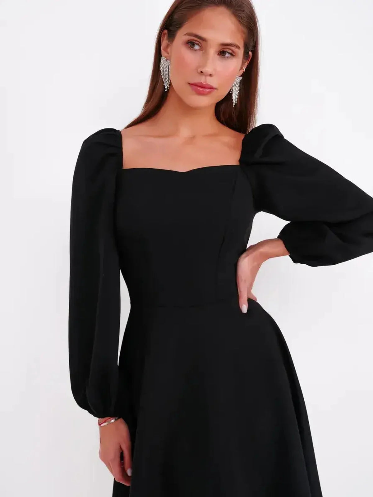 Elegant black mini dress with square neckline and voluminous long sleeves, perfect for formal occasions.