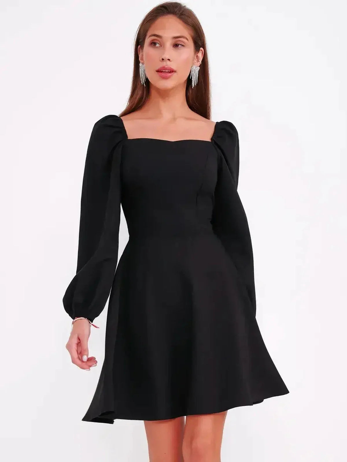 Stylish black mini dress with puff sleeves and a square neckline, perfect for summer parties and wedding guest occasions.