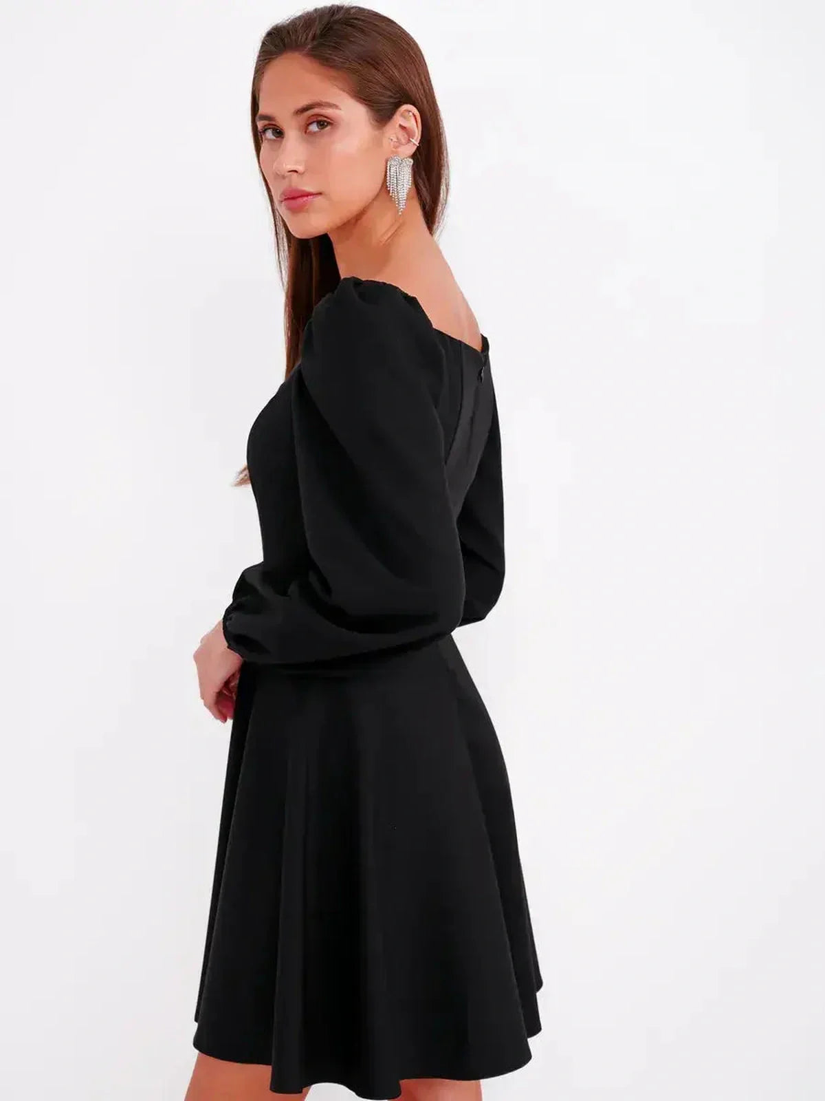 Elegant black mini dress with puff sleeves and a square neckline, perfect for wedding guests and cocktail events.