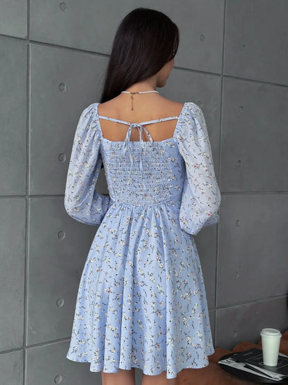 Back view of sky blue mini dress with floral pattern and long sleeves, ideal for summer, weddings, and casual outings.