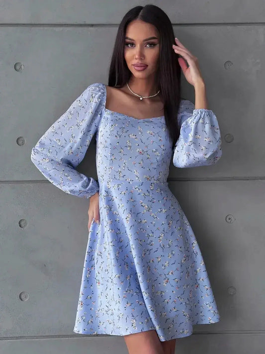 Sky blue mini dress with floral prints and long puff sleeves, perfect for weddings and summer events.