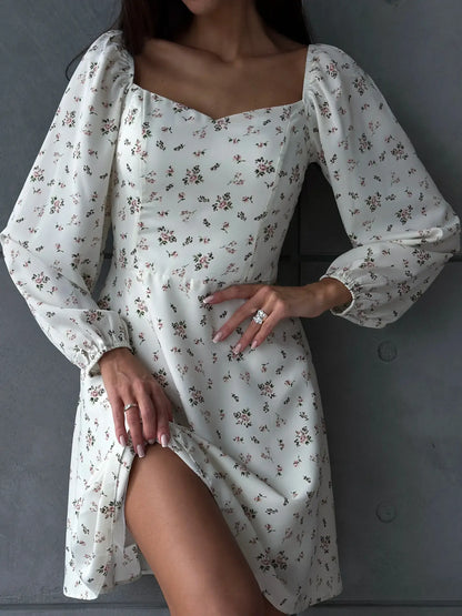 Elegant white summer dress with floral print, featuring long puff sleeves and a sweetheart neckline.