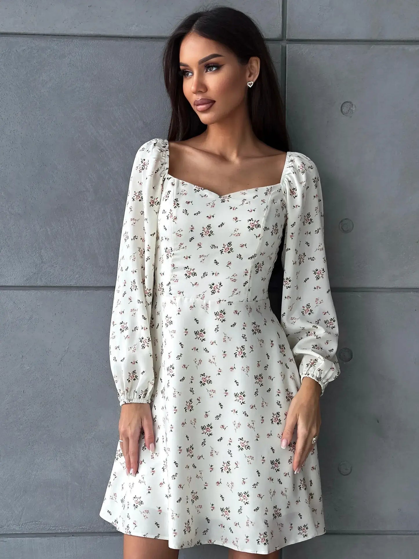 Chic floral dress with puffed sleeves and square neckline, perfect for summer celebrations and casual outings.